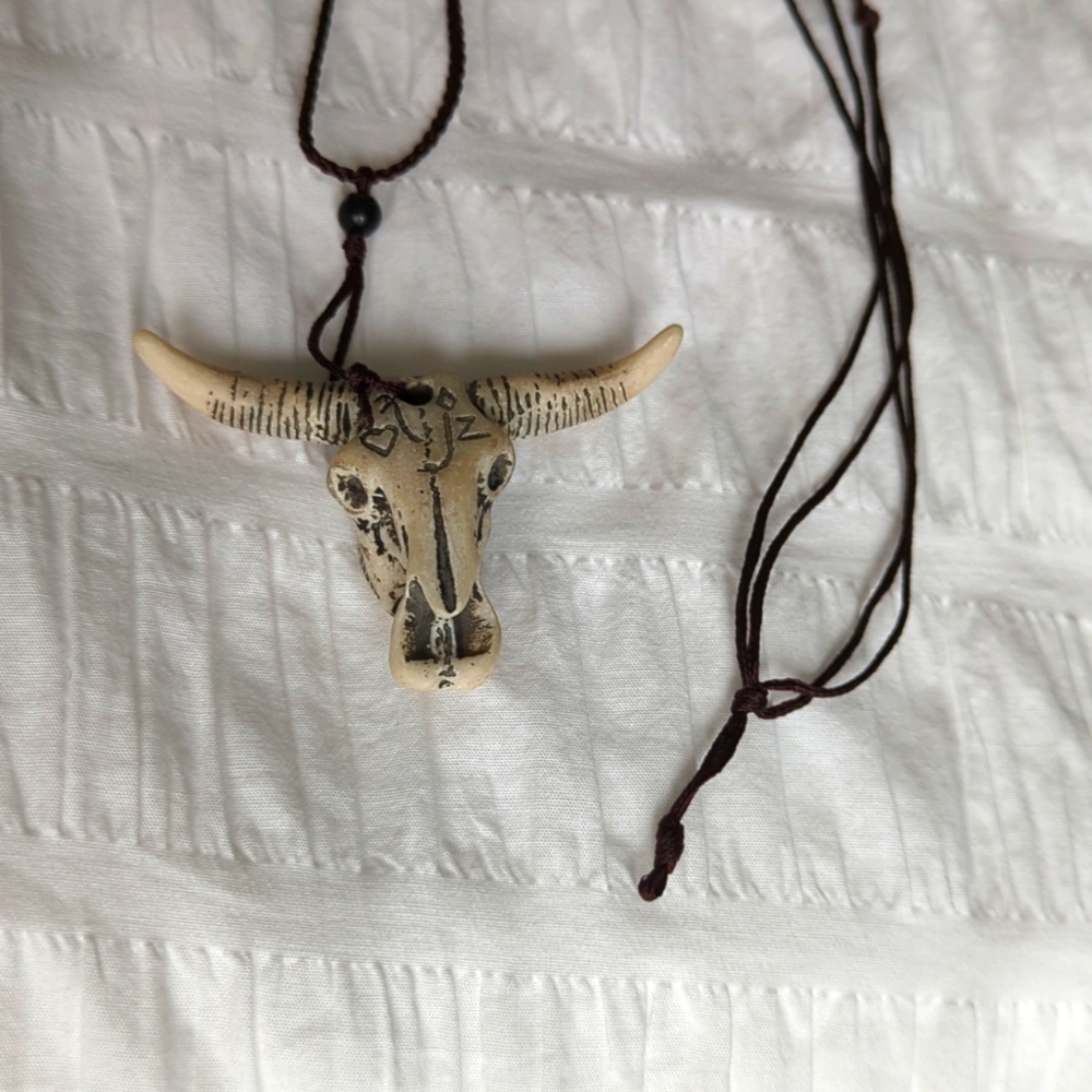 Carved steer on cord
